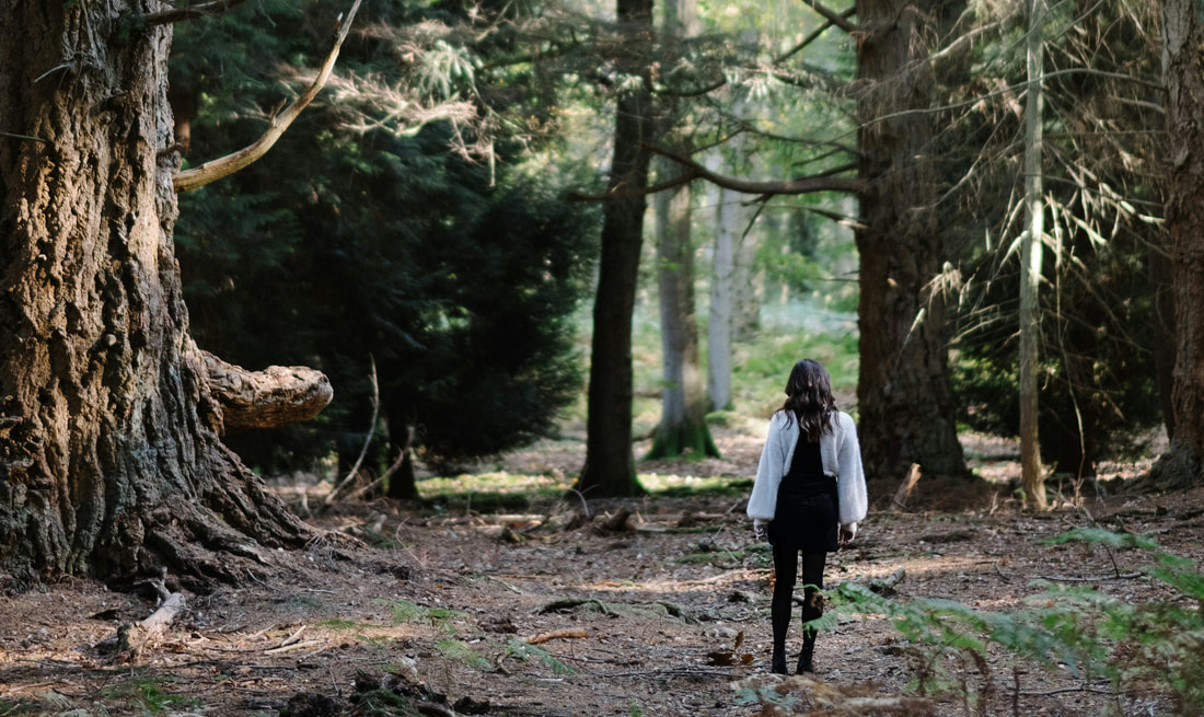 Woman walking in the woods, hiking